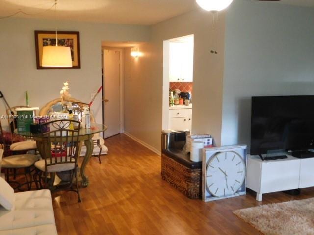 living room featuring hardwood / wood-style flooring and ceiling fan