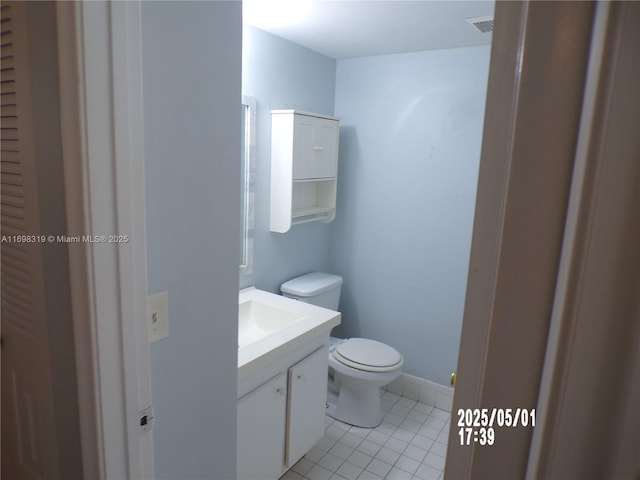 bathroom with tile patterned floors, vanity, and toilet