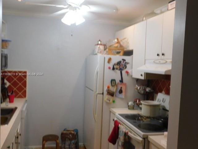 kitchen with backsplash, ceiling fan, sink, electric range, and white cabinetry