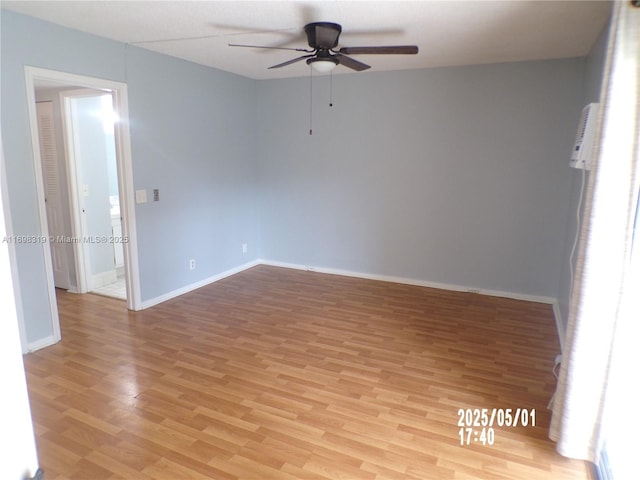 empty room featuring light wood-style floors, baseboards, and ceiling fan