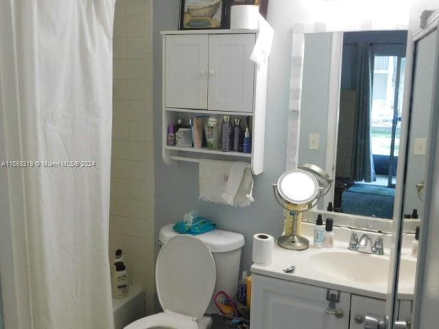 full bathroom featuring vanity, toilet, and shower / bath combo with shower curtain