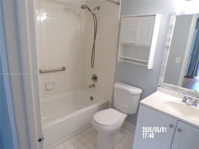 bathroom featuring tile patterned flooring, shower / tub combination, vanity, baseboards, and toilet