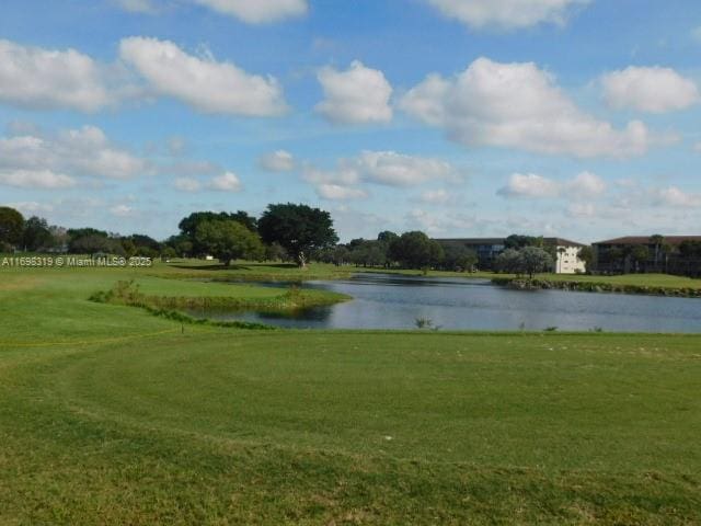 surrounding community featuring a lawn and a water view