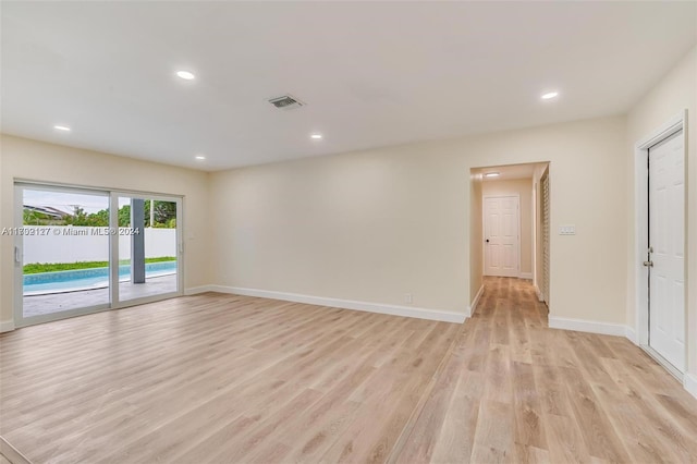 empty room with light hardwood / wood-style flooring