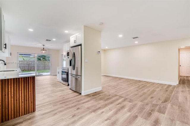 kitchen featuring white cabinets, light hardwood / wood-style floors, sink, and stainless steel appliances