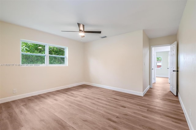 empty room with ceiling fan and light wood-type flooring