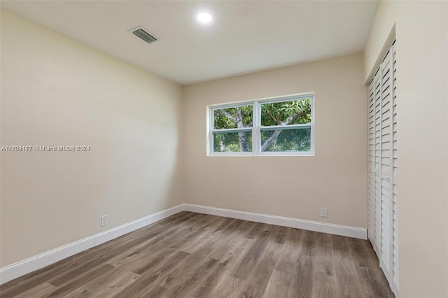 unfurnished bedroom featuring light hardwood / wood-style floors and a closet