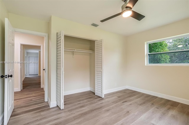 unfurnished bedroom with a closet, ceiling fan, and light hardwood / wood-style flooring