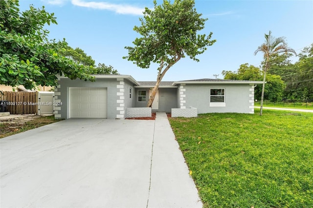 ranch-style house with a garage and a front yard