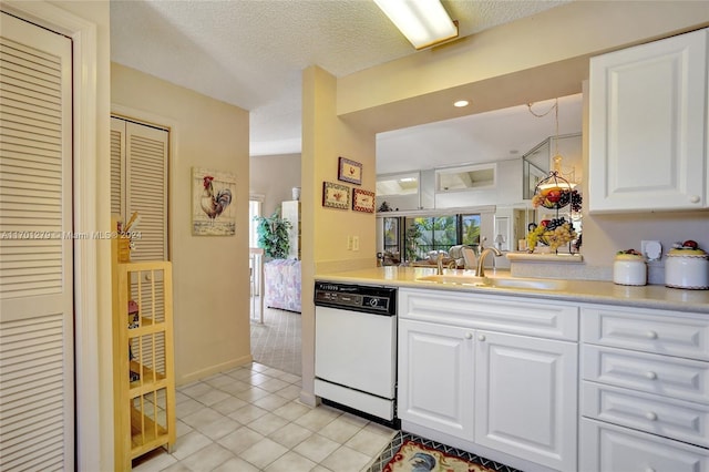 kitchen with a textured ceiling, sink, dishwasher, white cabinetry, and light tile patterned flooring