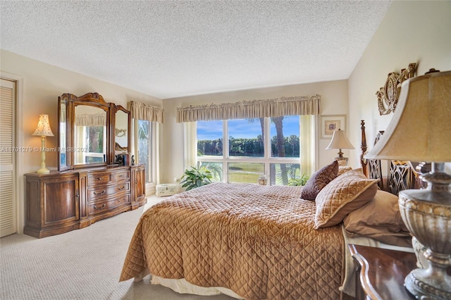 carpeted bedroom featuring a textured ceiling