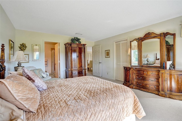 bedroom featuring carpet flooring, a closet, and a textured ceiling