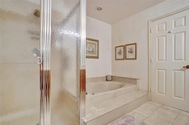 bathroom featuring tile patterned flooring and plus walk in shower