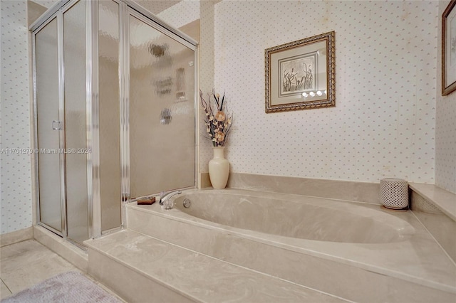 bathroom featuring tile patterned floors and separate shower and tub