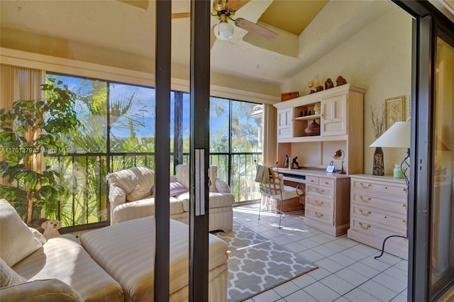 doorway to outside featuring ceiling fan, light tile patterned flooring, and built in desk