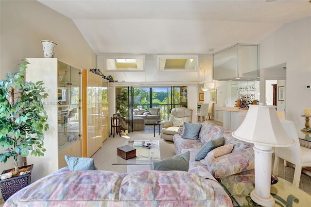 living room with light colored carpet, ceiling fan, and lofted ceiling