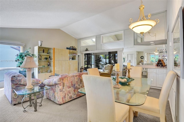 dining space featuring light colored carpet and vaulted ceiling