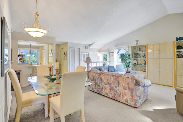 dining room with light carpet and lofted ceiling