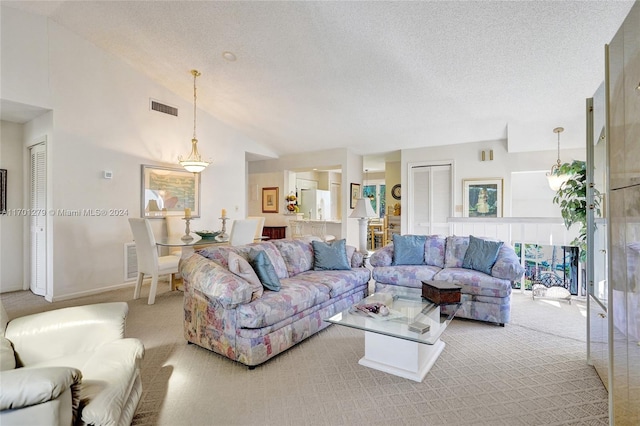 living room with light carpet, a textured ceiling, and high vaulted ceiling