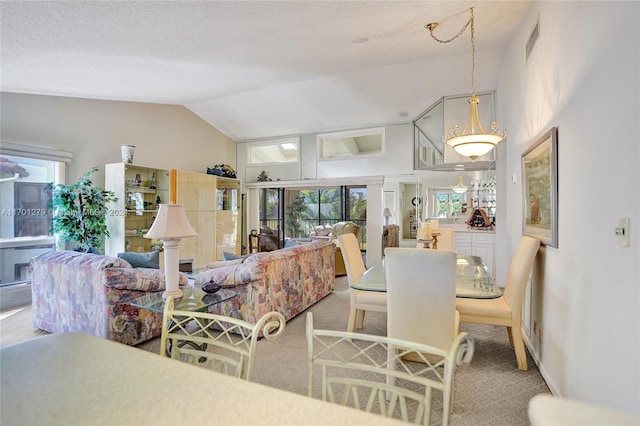 carpeted living room featuring vaulted ceiling