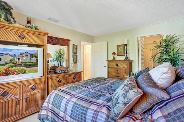 carpeted bedroom with a textured ceiling