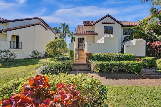 mediterranean / spanish home featuring a front yard