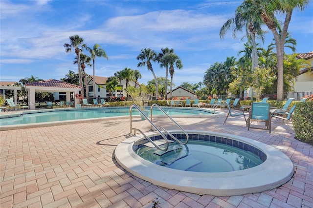 view of pool with a patio and a hot tub