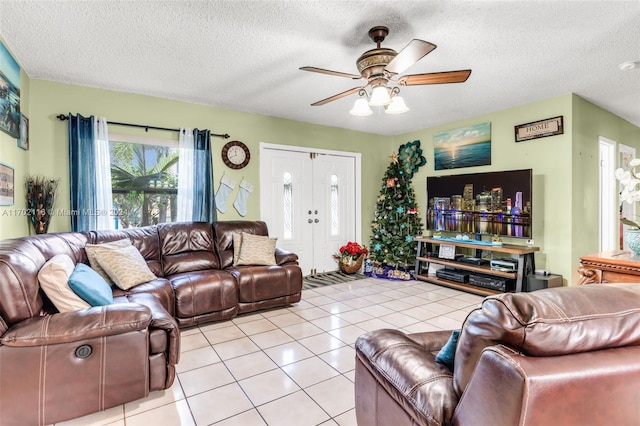 tiled living room featuring ceiling fan and a textured ceiling