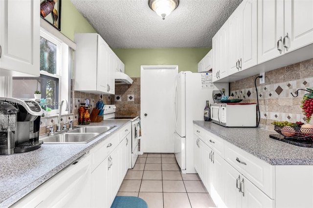 kitchen featuring white cabinets, backsplash, white appliances, and sink