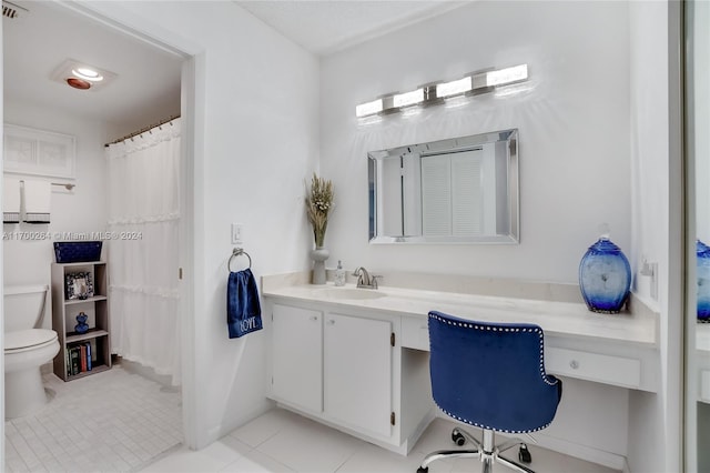 bathroom with tile patterned flooring, vanity, and toilet