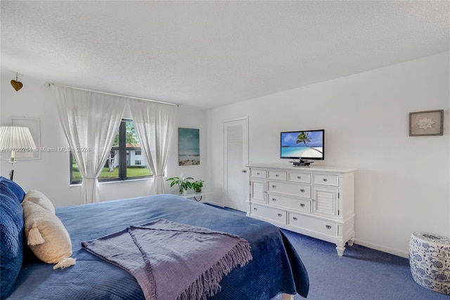 carpeted bedroom with a textured ceiling