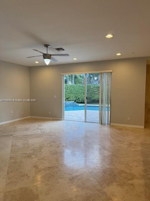 kitchen with white cabinets, appliances with stainless steel finishes, and light stone counters