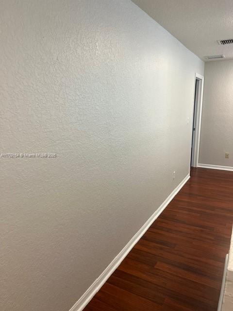 hall featuring dark wood-type flooring