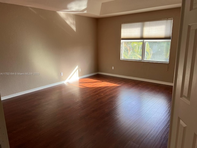 unfurnished room featuring dark hardwood / wood-style flooring