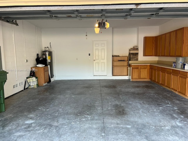 garage with water heater and a garage door opener