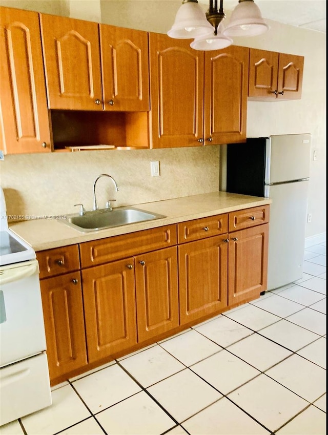 kitchen featuring tasteful backsplash, fridge, sink, and white electric range