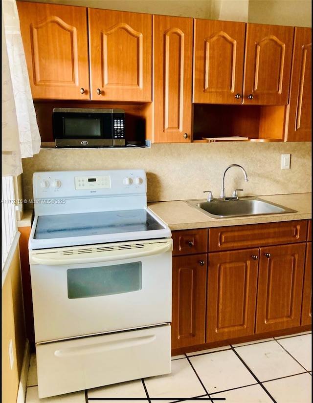 kitchen with light tile patterned flooring, white electric stove, sink, and backsplash