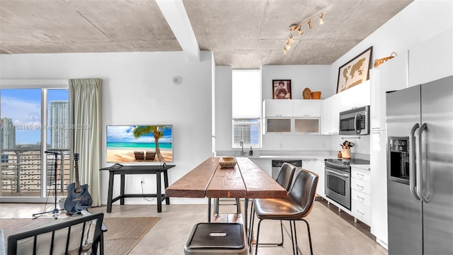 kitchen with sink, white cabinets, and stainless steel appliances