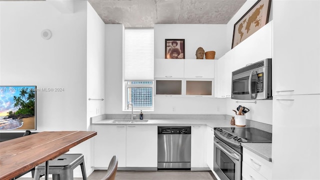 kitchen with white cabinets, stainless steel appliances, and sink