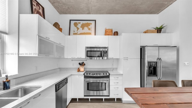 kitchen featuring white cabinets, sink, and stainless steel appliances