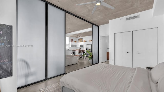 bedroom with ceiling fan and stainless steel fridge