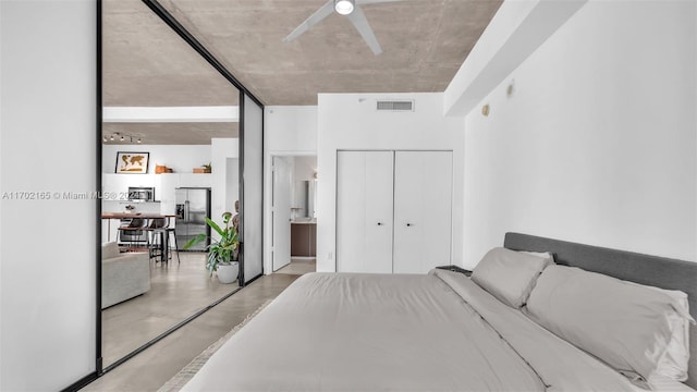 bedroom featuring stainless steel fridge with ice dispenser and ceiling fan