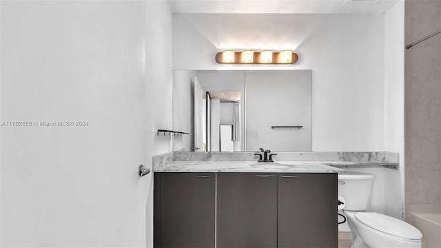 full bathroom with shower / washtub combination, vanity, and toilet