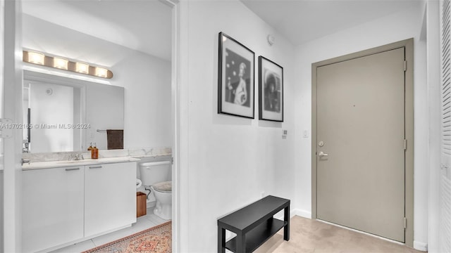 interior space with light tile patterned floors and sink