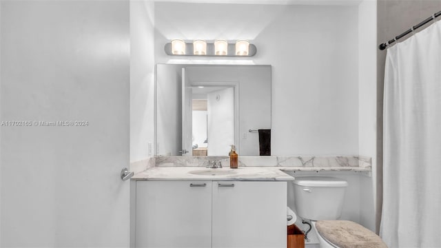 bathroom featuring vanity and toilet