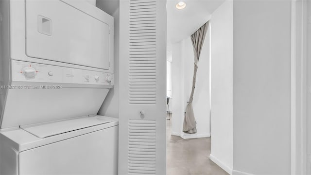 laundry area featuring stacked washer and dryer