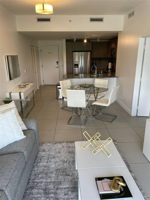 living room with tile patterned floors and sink