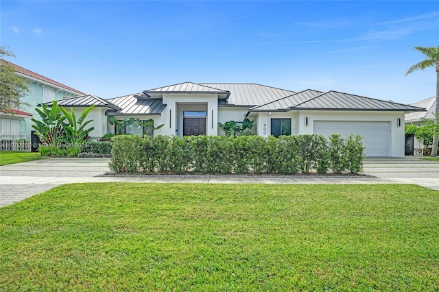 view of front of house with a front yard and a garage