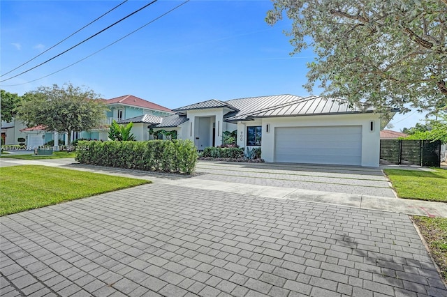 view of front of property with a garage and a front lawn