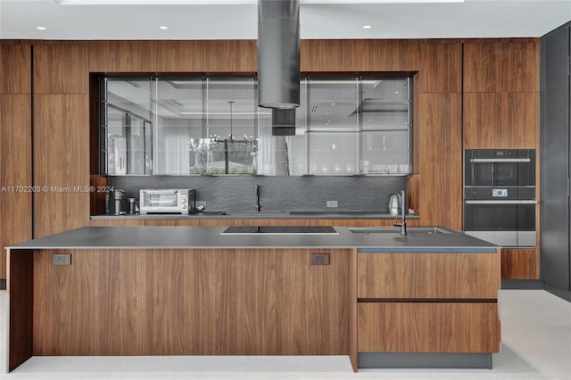 kitchen with black appliances, a kitchen island, and sink